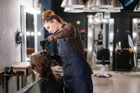 A stylist working on a client in a modern hair salon
